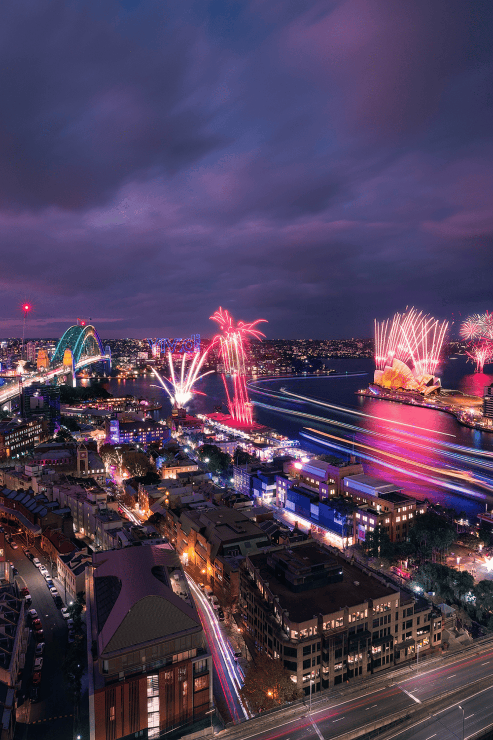 Colorful fireworks over Sydney Harbour at night, showcasing vibrant cityscape and iconic landmarks.