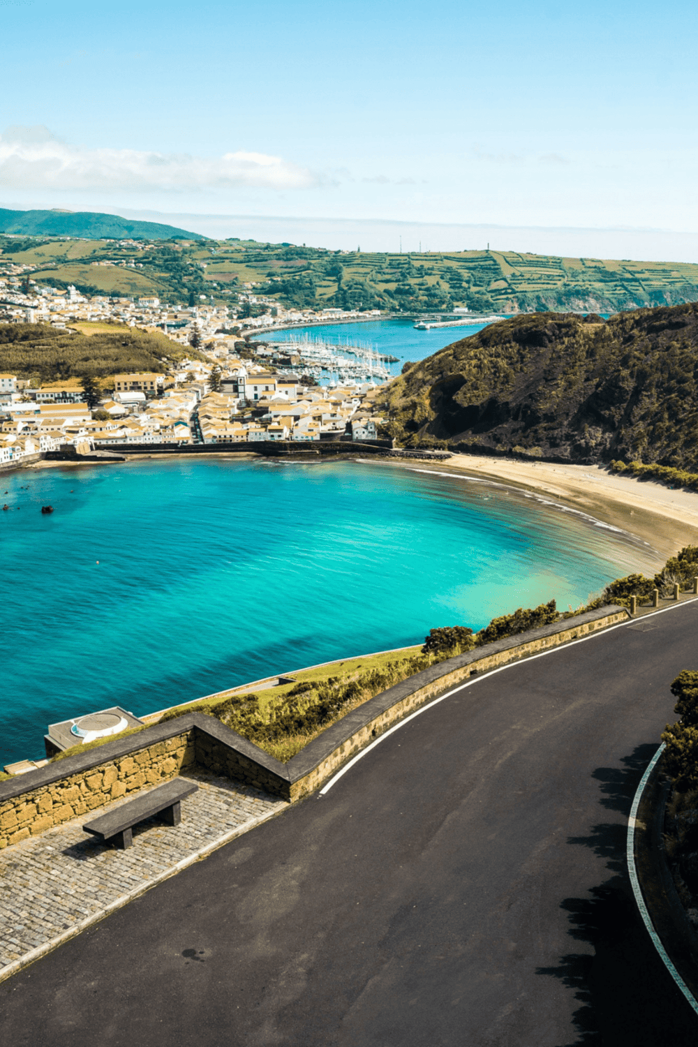 Vibrant coastal town with harbor and scenic hillside views, perfect for travel planning and navigation.