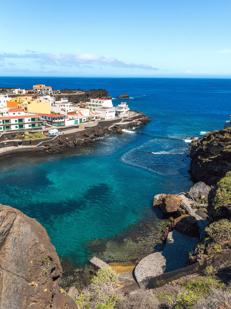 Stunning coastal village with vibrant houses and clear blue waters, perfect for travel and exploration.