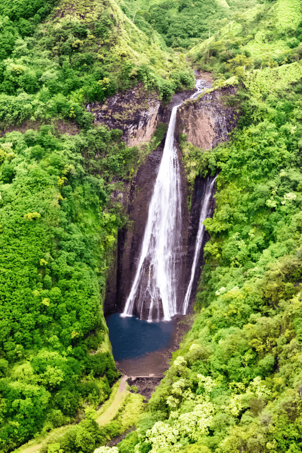 Waterfall nestled in lush green forest, scenic natural landscape for adventure travel.