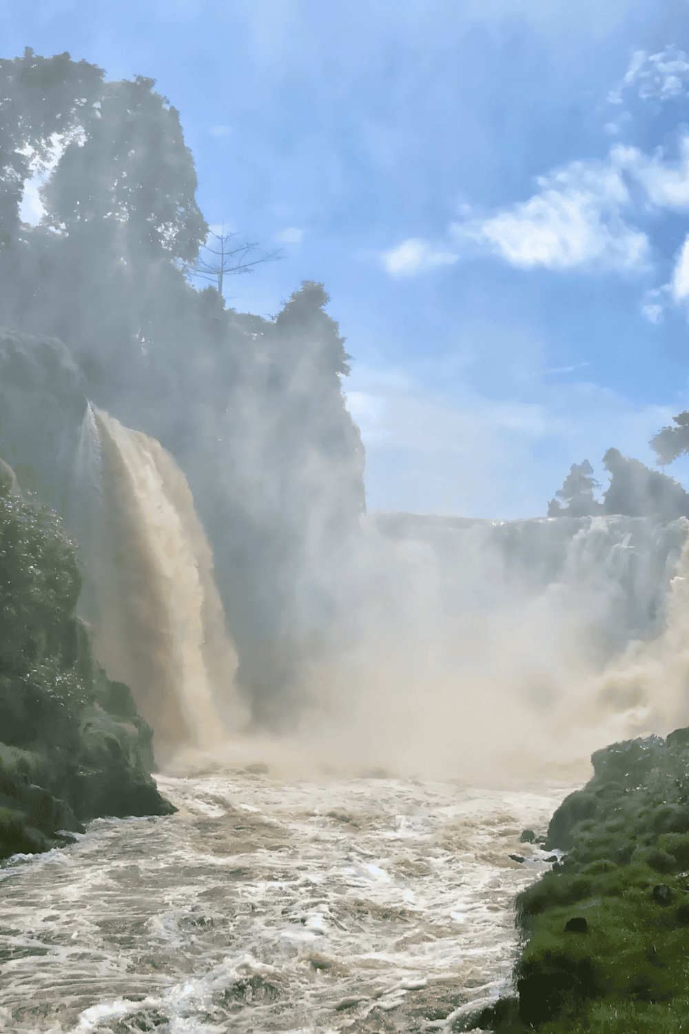 Waterfalls and lush greenery at QuestForDirections scenic location.
