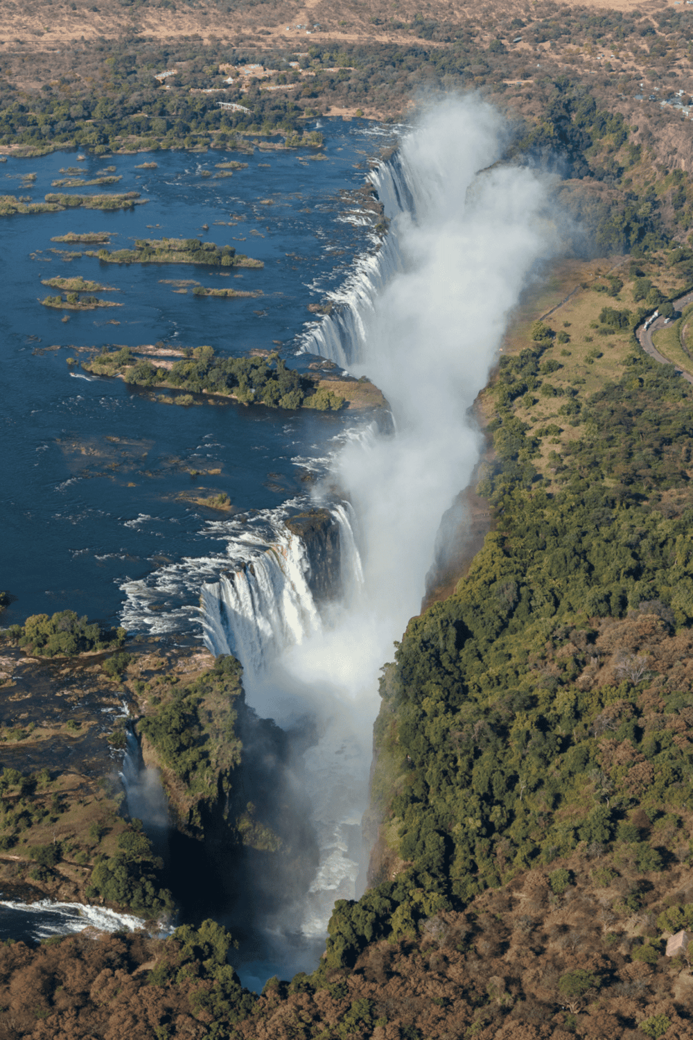 1. Large waterfall at Iguazu Falls in Argentina, lush green surroundings and mist rising.