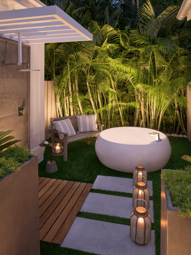 Relaxing outdoor garden with modern bathtub and lush greenery, perfect for outdoor spa or relaxation space.