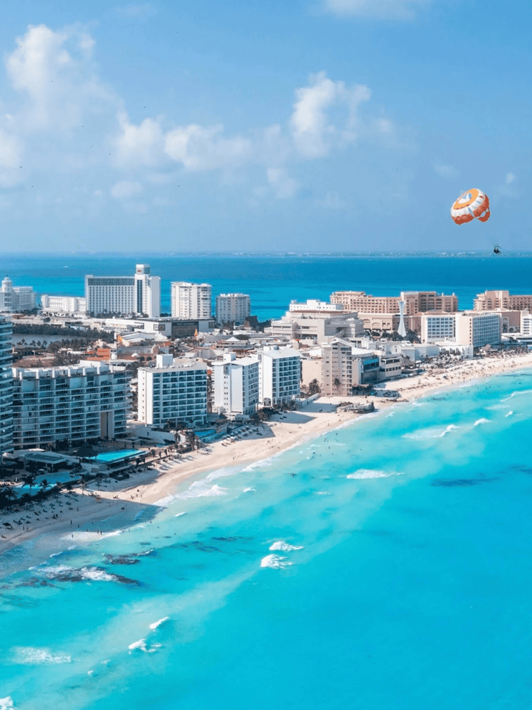 Breathtaking aerial view of Miami Beach with high-rise hotels and coastline under blue sky.
