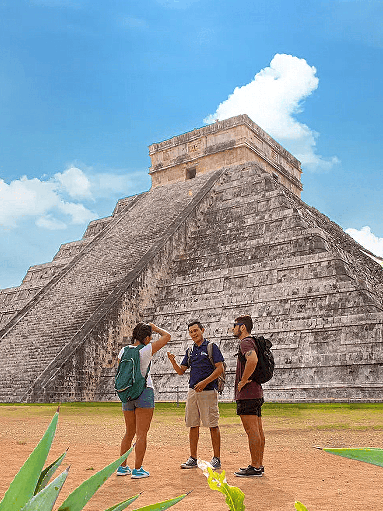 Ancient Mayan pyramid in Mexico, tourists exploring Mayan archaeological site, example of historical travel destinations.