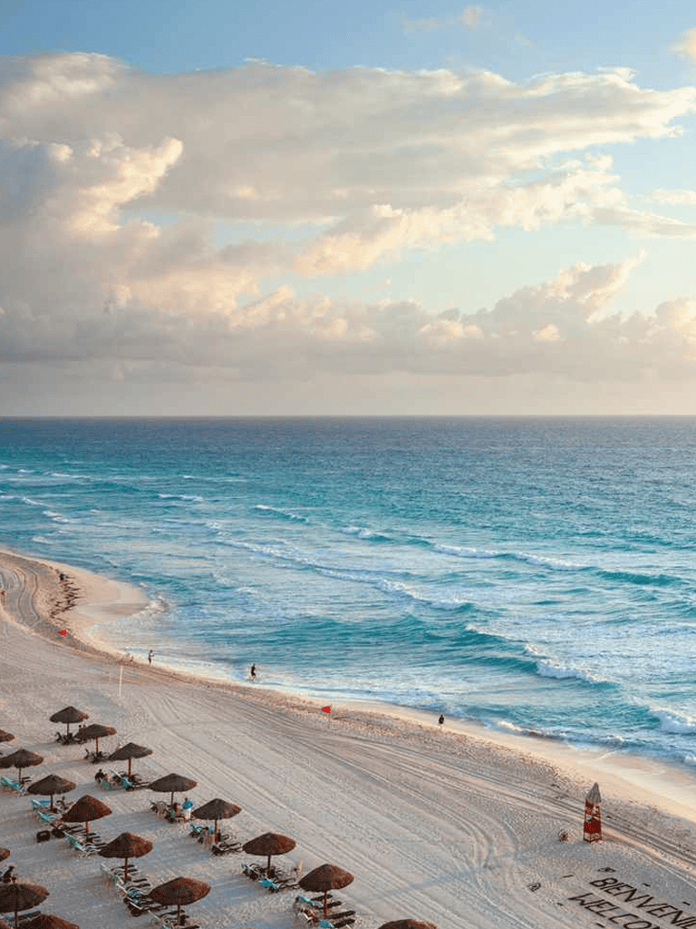 Sunny beach destination with clear blue waters and relaxing seaside umbrellas.