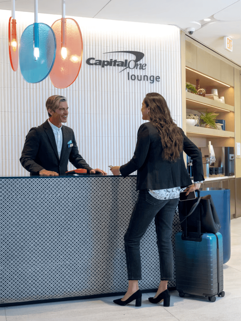 Modern airport lounge reception with staff providing assistance, showcasing comfort and excellent customer service.