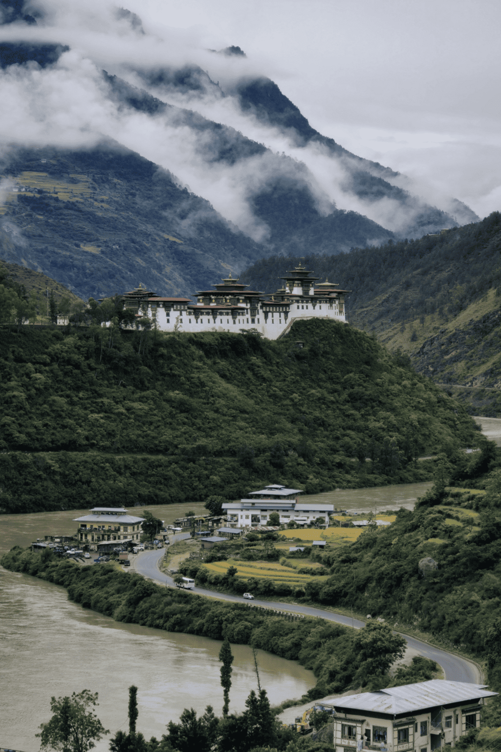 Stunning Himalayan mountain landscape with a traditional fortress overlooking lush green valleys.