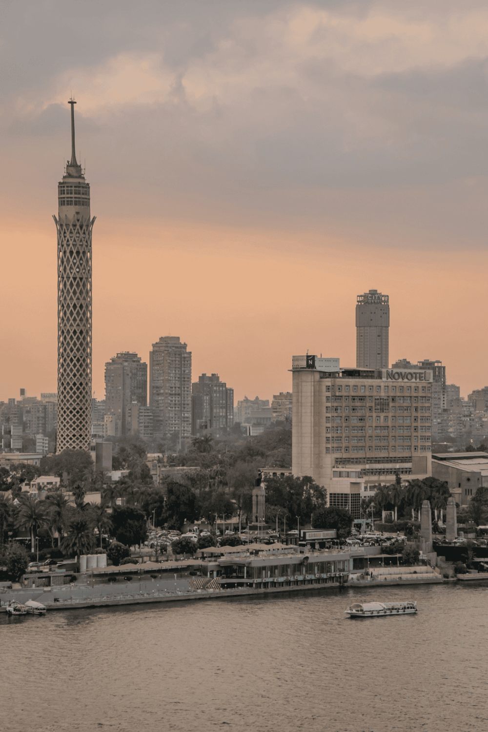 Modern Cairo skyline featuring Cairo Tower and cityscape at sunset for travel and navigation insights.