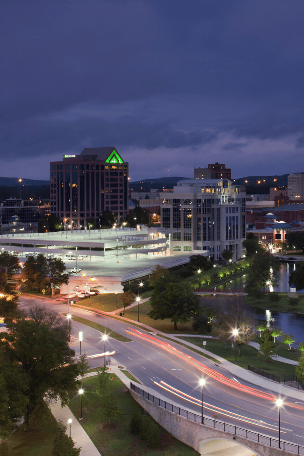 Night cityscape with illuminated buildings and streets, showcasing Urban Navigation and City Directions services.