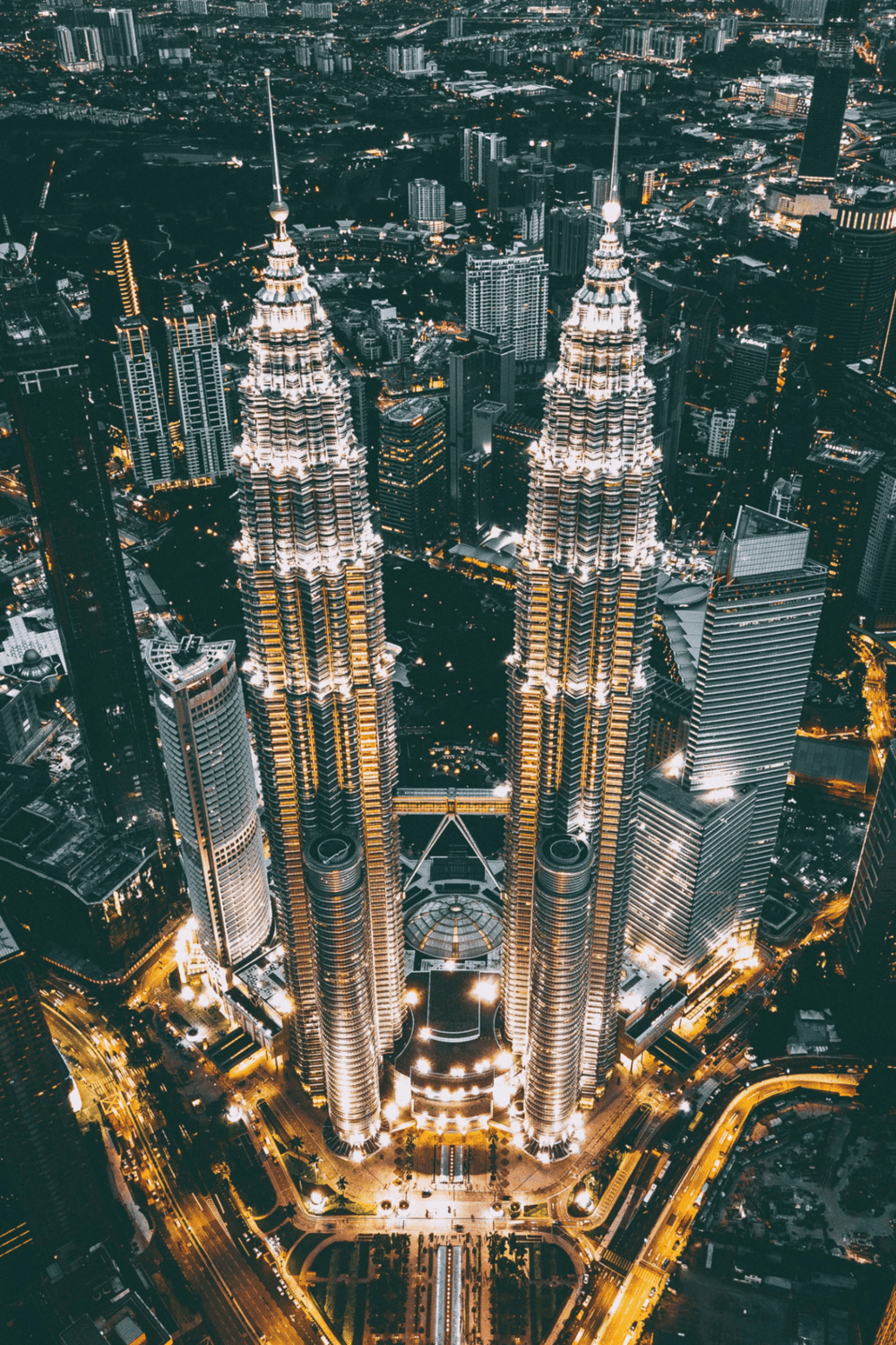 Petronas Towers illuminated at night in Kuala Lumpur city skyline, Malaysia.