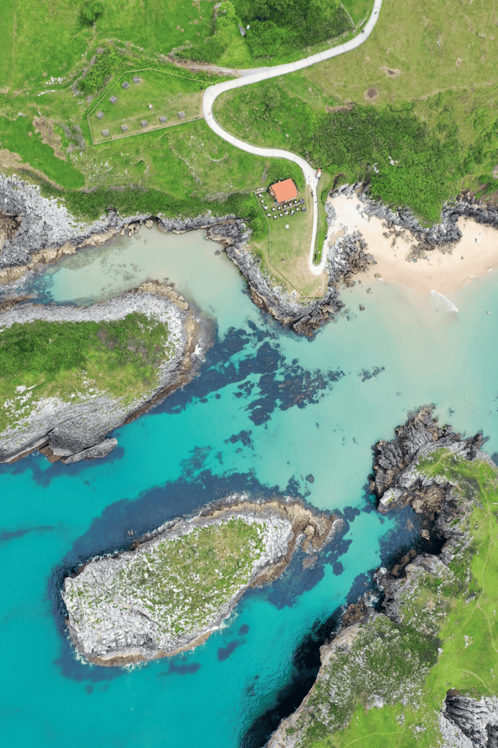 Vibrant aerial view of coastal cliffs, turquoise waters, and lush greenery, highlighting scenic landscapes and natural beauty.