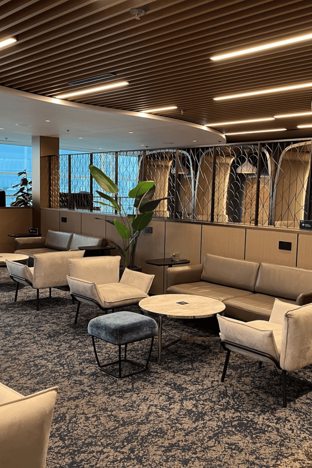 Modern airport lounge with comfortable seating and stylish decor for traveler relaxation.