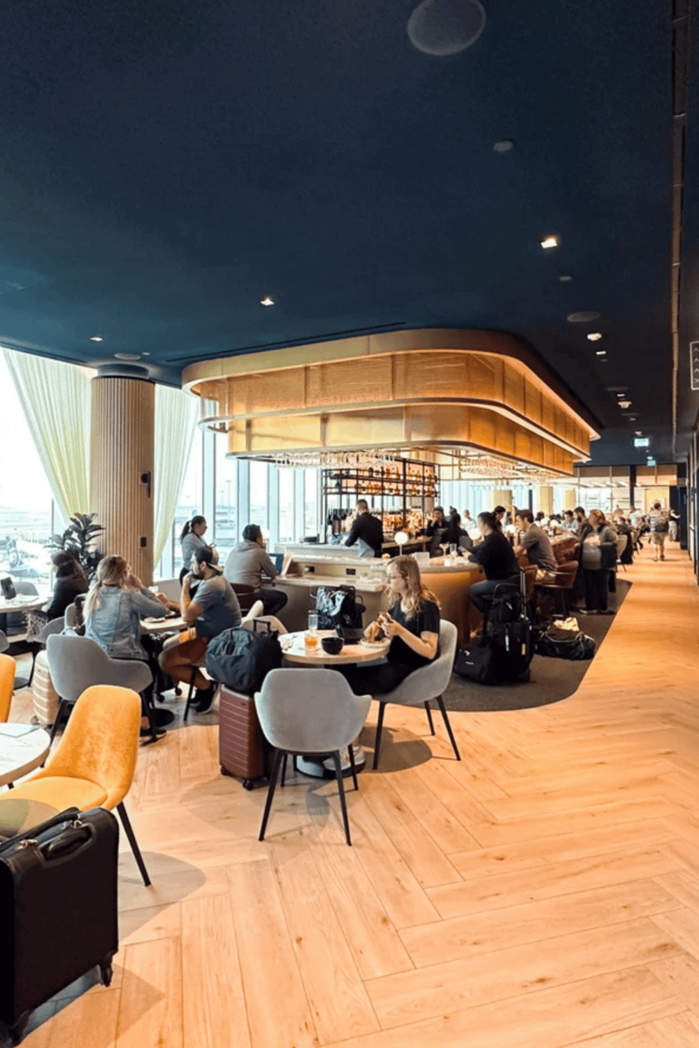 Comfortable airport lounge with modern design and ample seating, perfect for travelers seeking relaxation.
