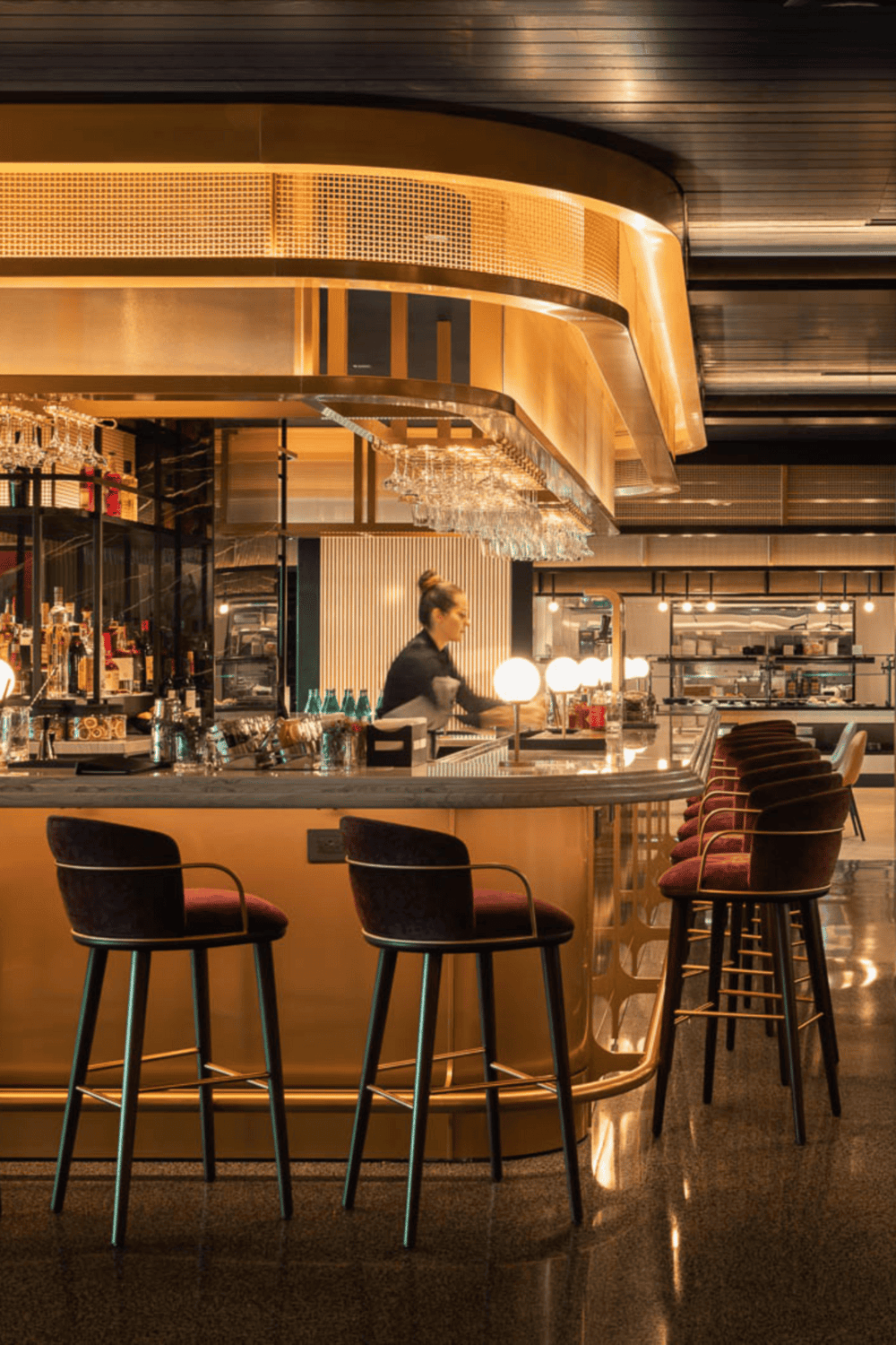 Luxurious modern bar interior with warm lighting and elegant seating.
