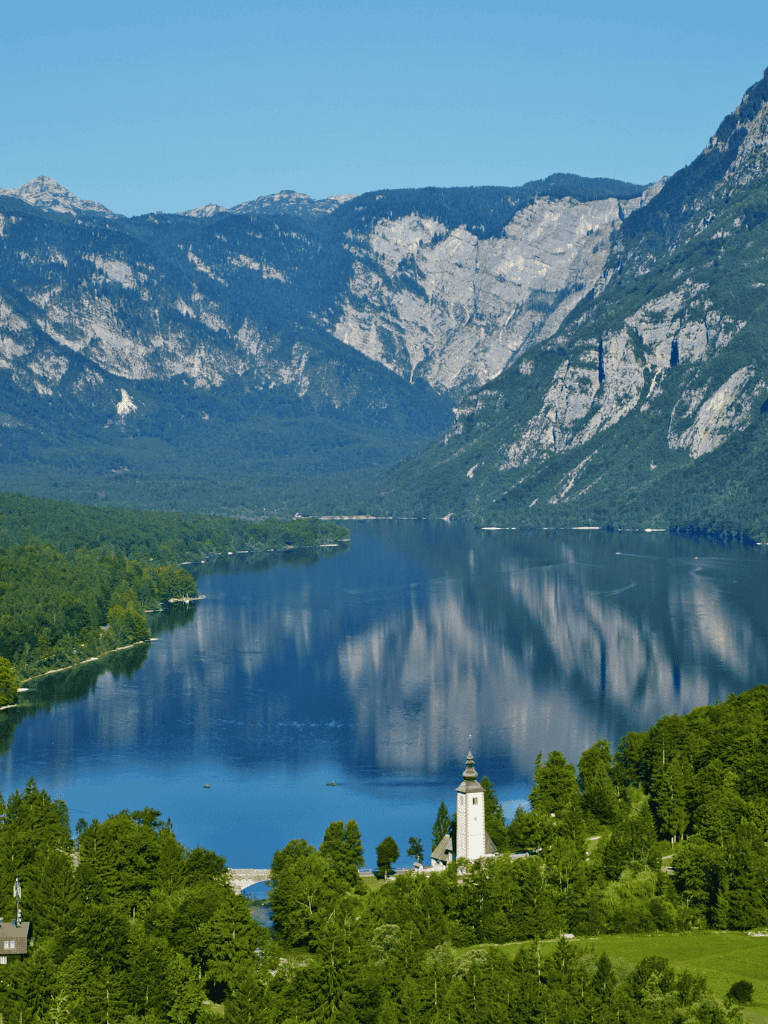 Serene river landscape with mountains and lush greenery, ideal for travel and outdoor adventures.