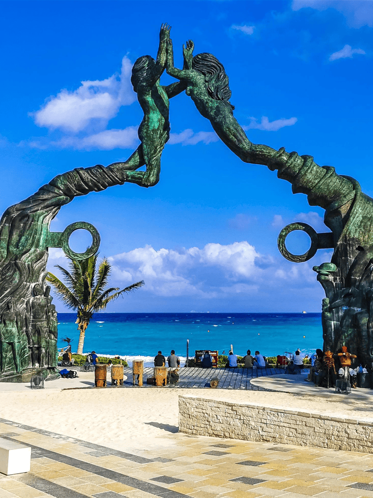 Vivid image of the famous "Portal to the Pacific" sculpture at Quest for Directions, overlooking a sunny beach and ocean view.