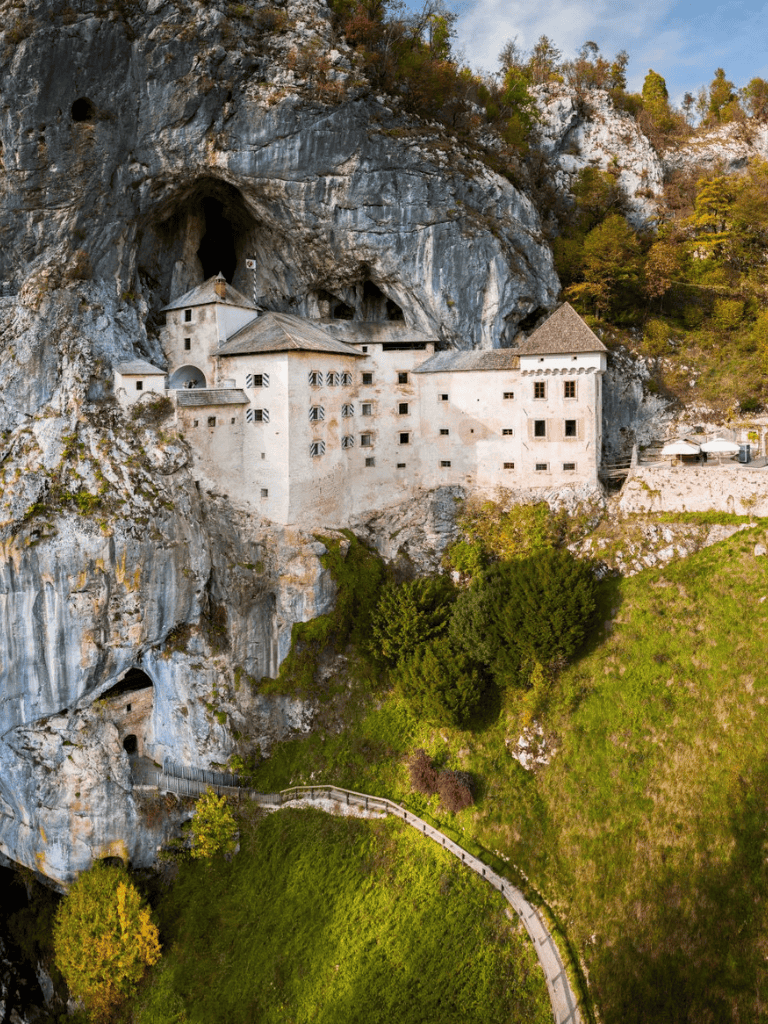Climb the stunning mountain castle built into a cave in the scenic Alps. Explore centuries-old architecture and breathtaking views.