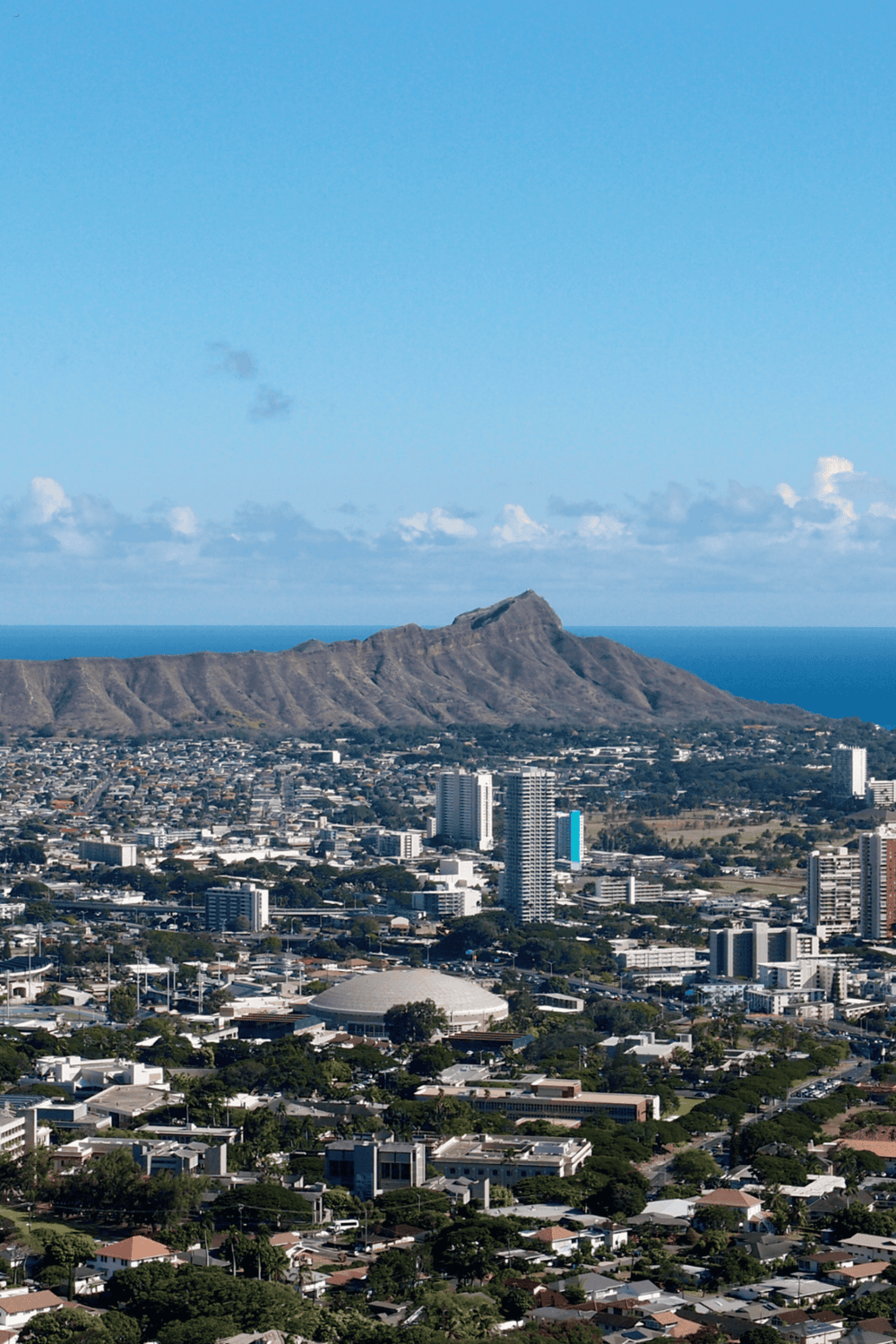 Aerial view of Honolulu skyline with Diamond Head volcanic crater in background, highlighting travel and tourism in Hawaii.