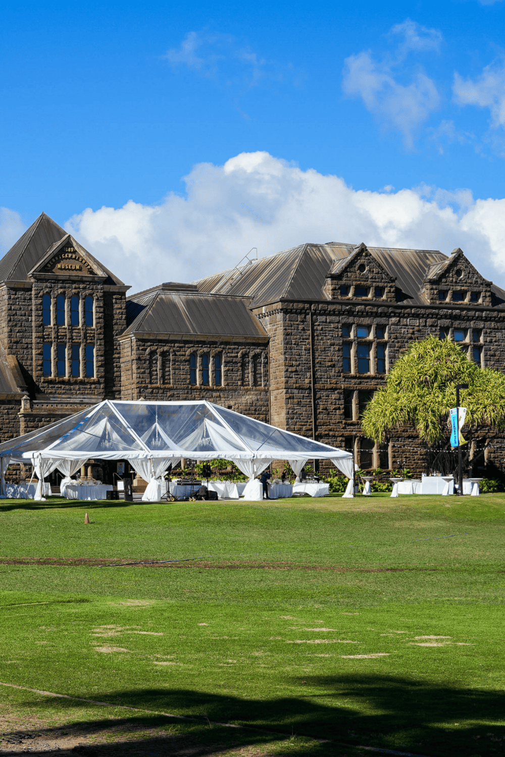 Historic museum building with outdoor event setup and tent, located at Quest for Directions.