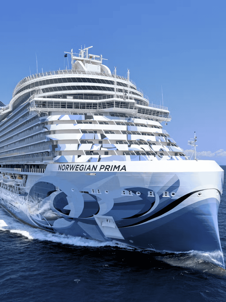Luxury cruise ship Norwegian Prima sailing on blue ocean waters, perfect for travel adventures.
