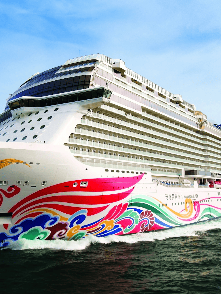 Luxurious cruise ship with colorful whale artwork, docked at port for luxury travel and vacation cruises.