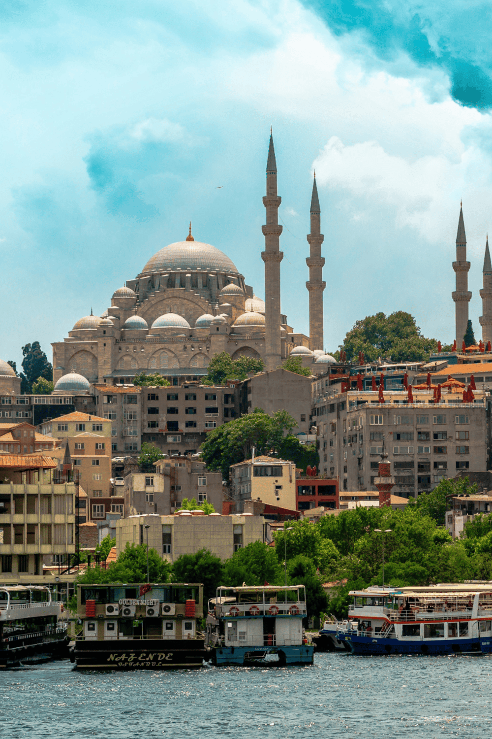 Majestic mosque overlooking Istanbul skyline and Bosphorus with boats, historic architecture, popular tourist destination.