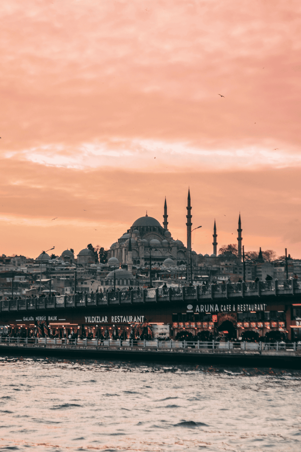 Majestic mosque view in Istanbul at sunset with cityscape and waterfront.