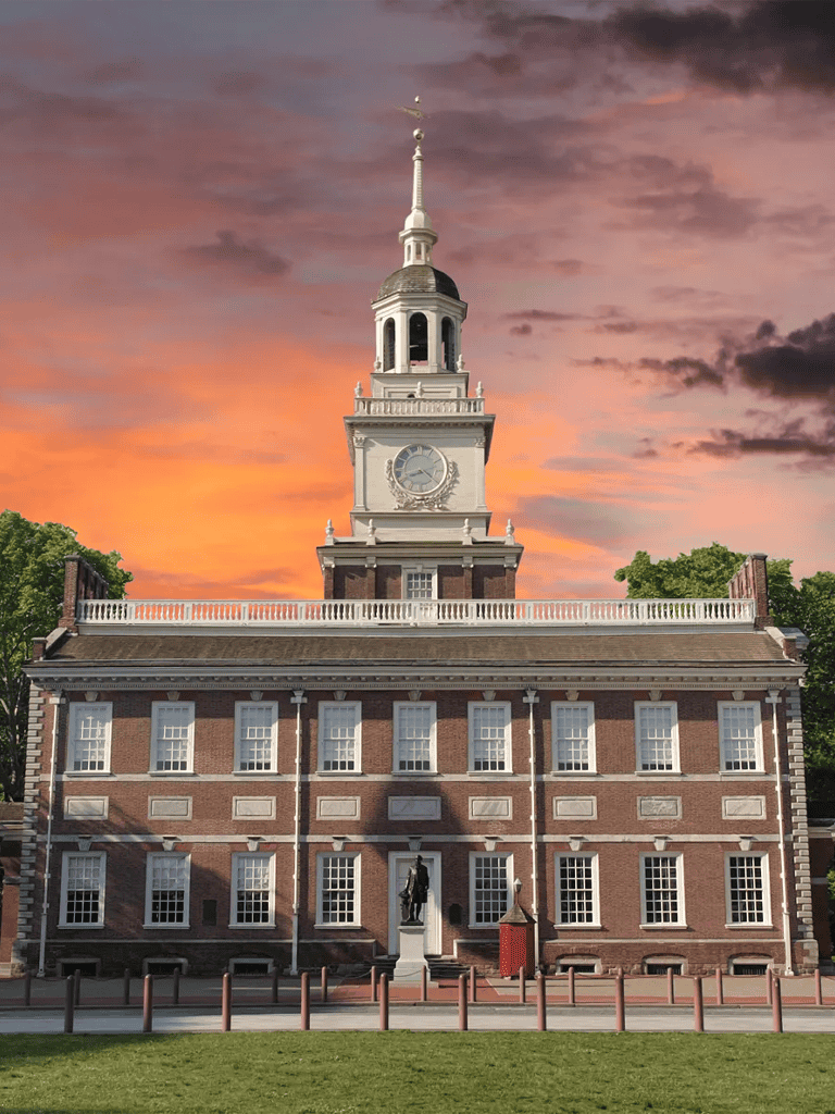 Historic colonial building with clock tower at sunset, capturing classic American architecture for travel and historical exploration.