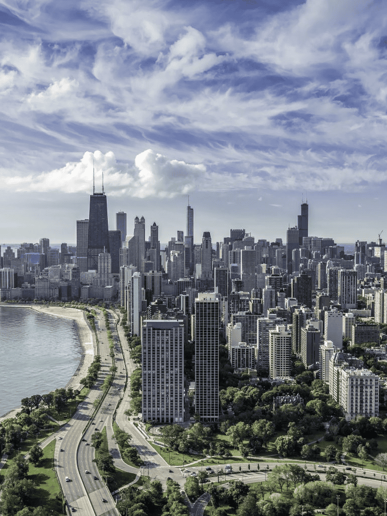 Vibrant Chicago skyline with iconic skyscrapers and Lake Michigan view at sunset.