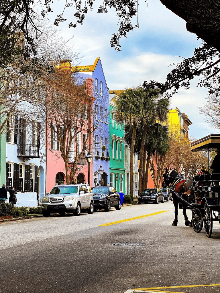 Colorful row of pastel houses on a lively city street with vintage carriages and palm trees.