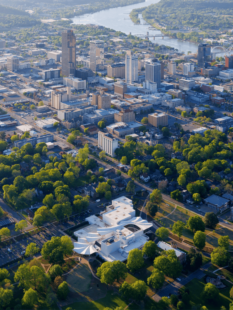 Modern downtown city skyline with high-rise buildings and river view in daytime.
