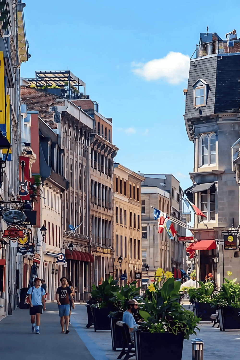 Vibrant city street with historic architecture, shopping, dining, and pedestrian activities.