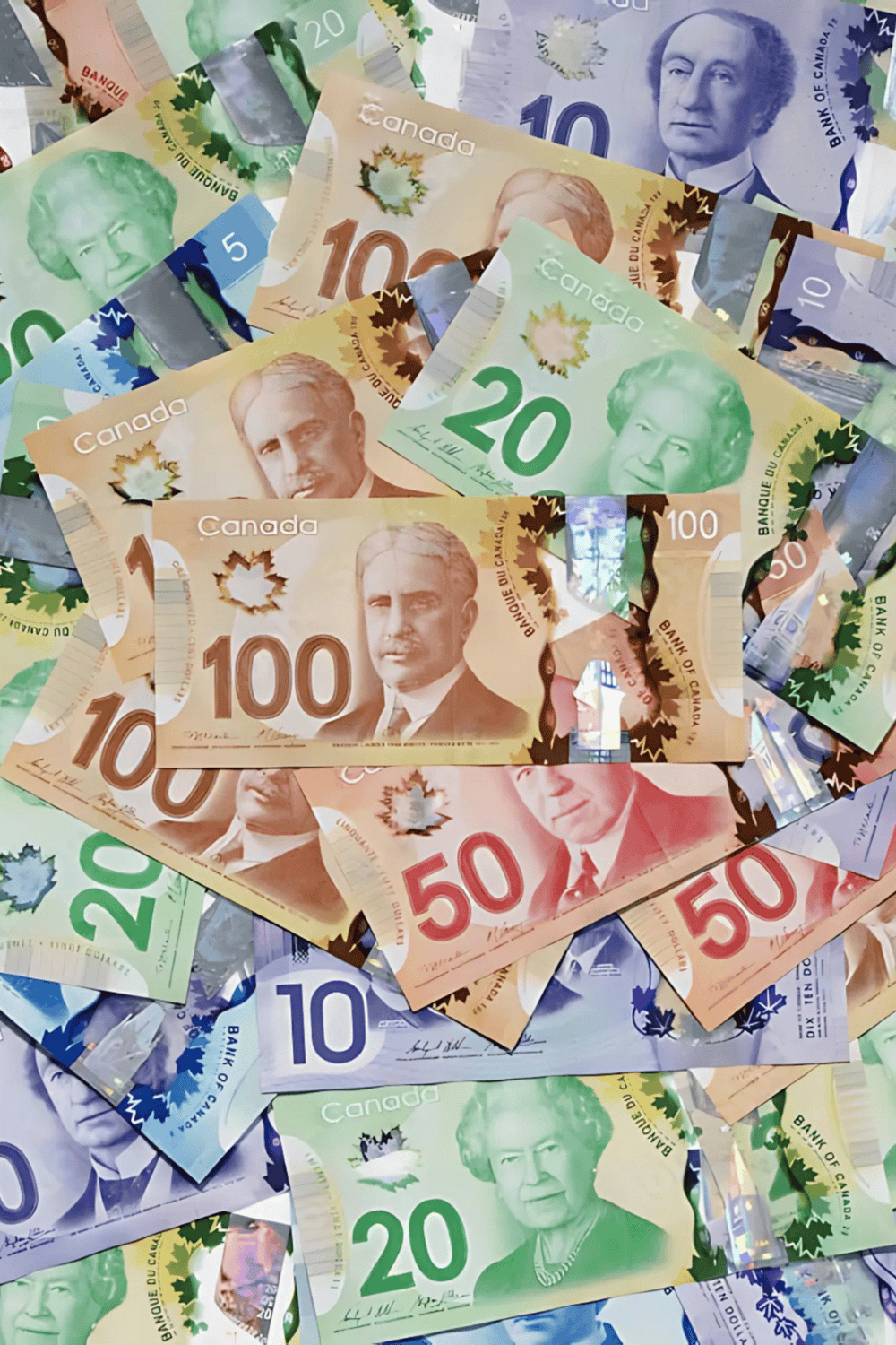 Canadian banknotes showcasing various denominations, colorful and diverse in design.