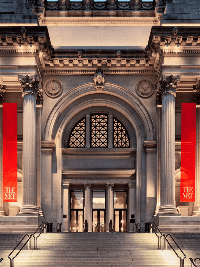 Elegant museum entrance with grand columns and historical architecture, showcasing QuestForDirections expertise in cultural navigation.