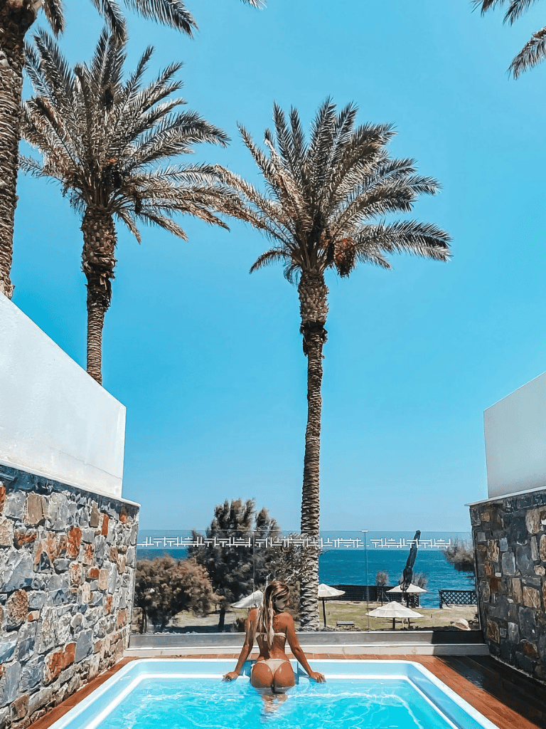 Relaxing poolside scene with palm trees and ocean view at QuestForDirections.