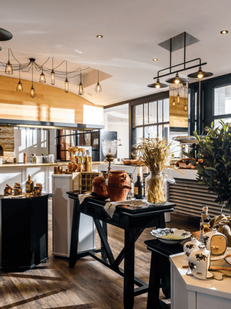 Luxurious modern interior of a boutique shop with wooden accents and decorative pottery displays.