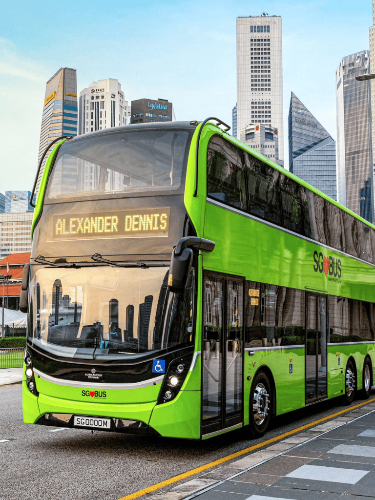 SG bus in city skyline, public transportation, eco-friendly bus, downtown bus service, city transit.