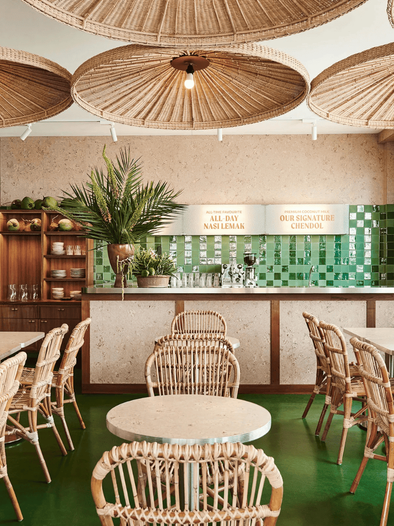 Vibrant tropical cafe with wooden accents, green tiled wall, and wicker furniture for relaxed dining experience.