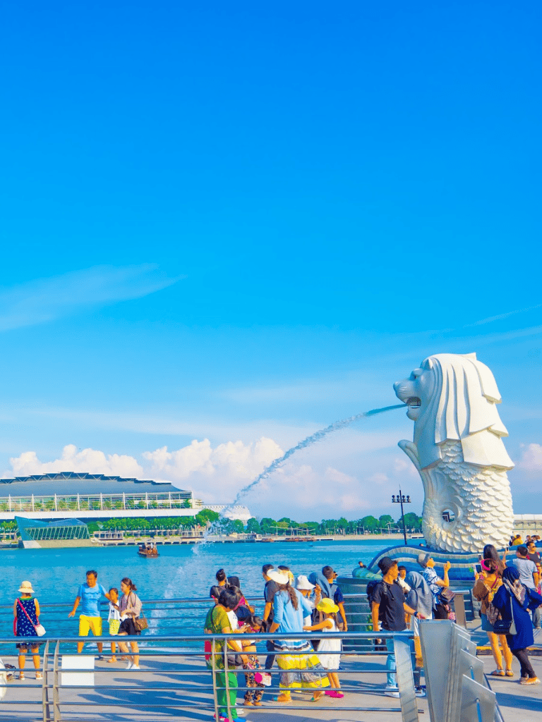 Colorful Singapore Merlion park with tourists, iconic landmark, travel destination, tourism attraction.