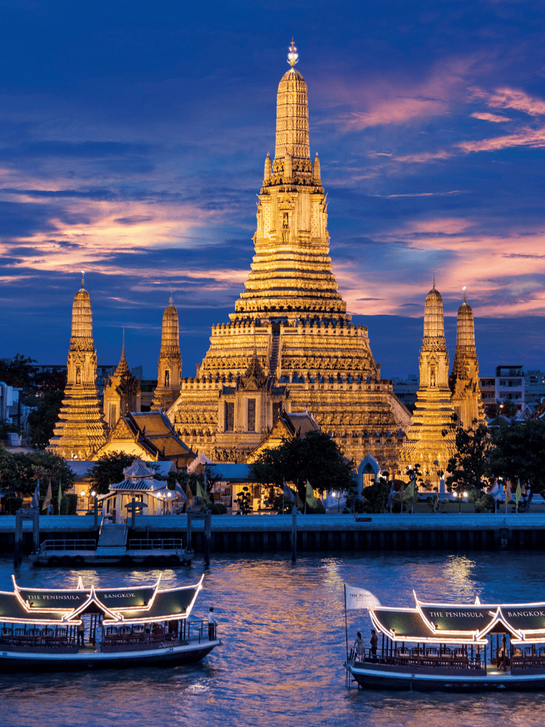 Stunning image of Wat Arun, Bangkok, illuminated at sunset on the Chao Phraya River.