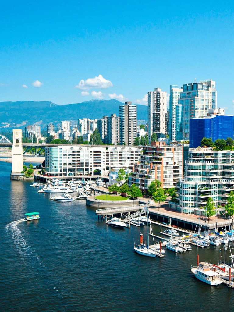 Modern city skyline with waterfront marina and high-rise buildings, Vancouver BC.