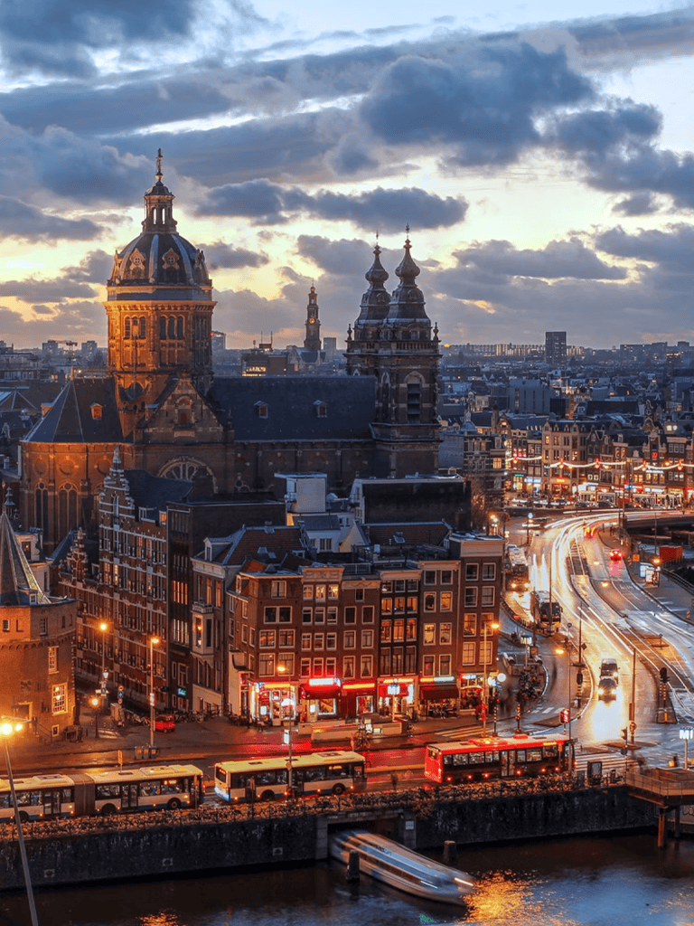 1. Historic European cityscape with church spires and busy streets at sunset.