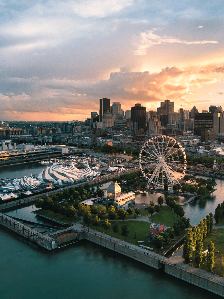Vibrant city skyline with Ferris wheel and waterfront, stunning sunset over downtown Seattle.