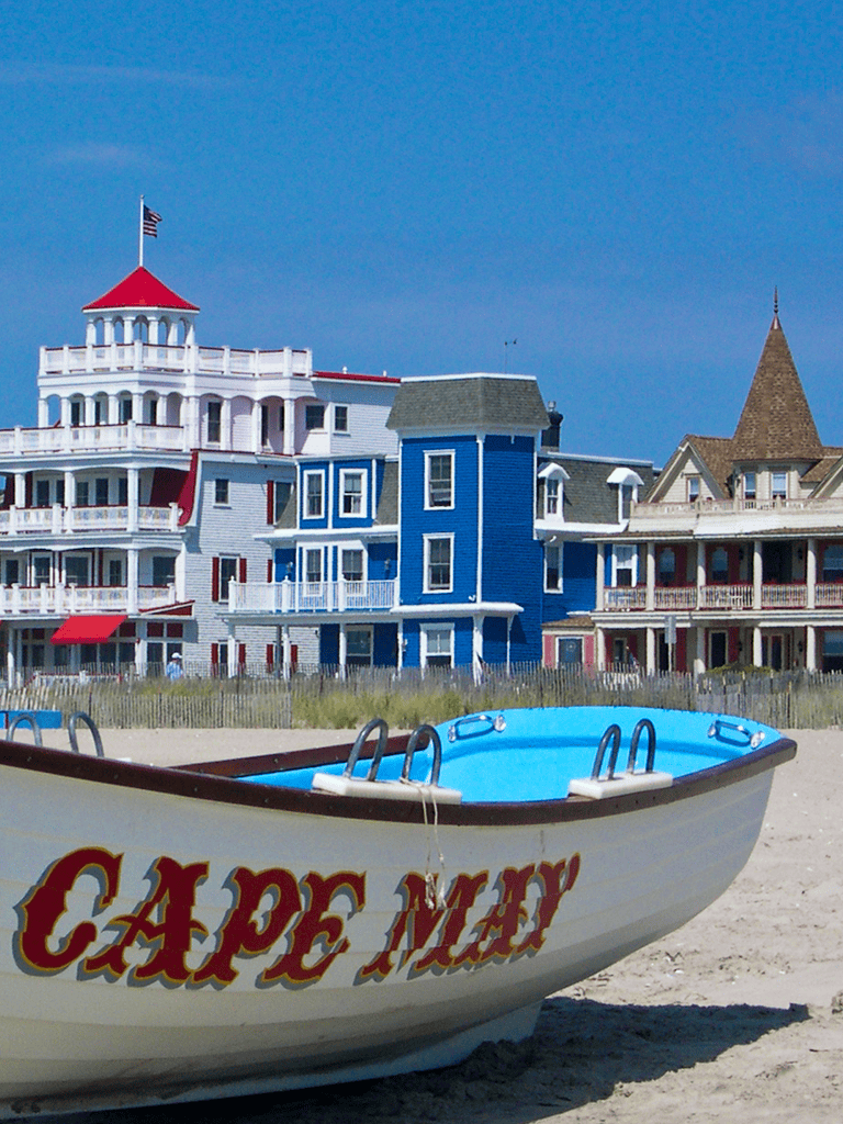 Colorful seaside resort houses in Ocean City, Maryland, with a blue pool in the foreground.