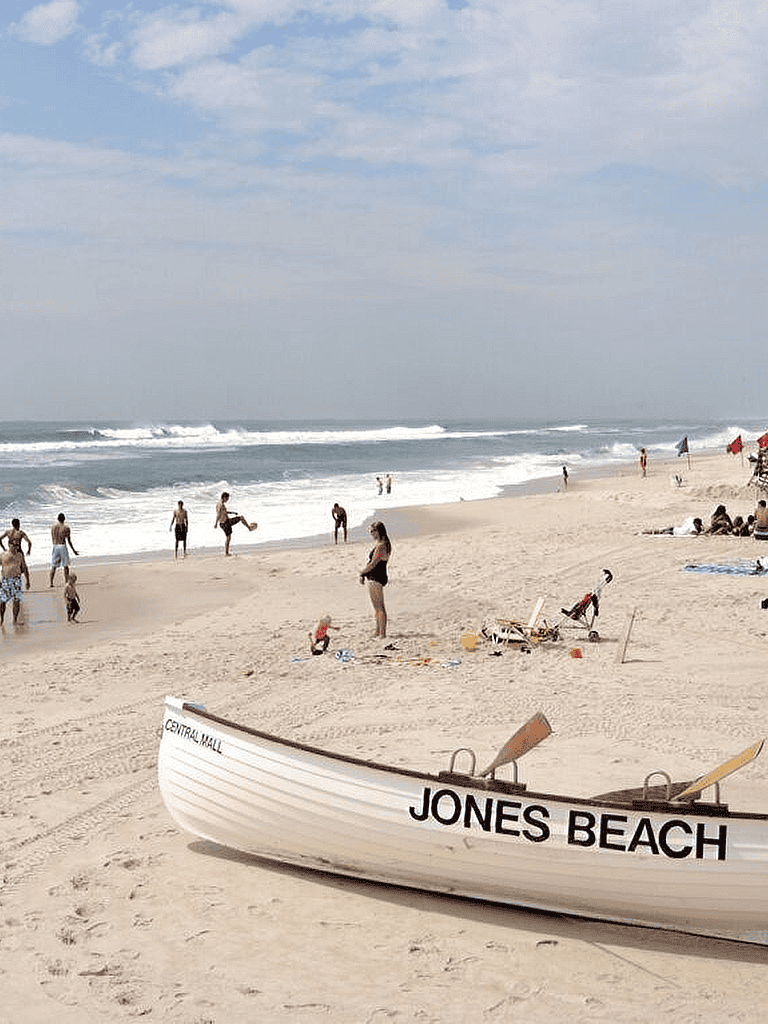 Bright Jones Beach on a sunny day with families enjoying the beach and ocean waves.