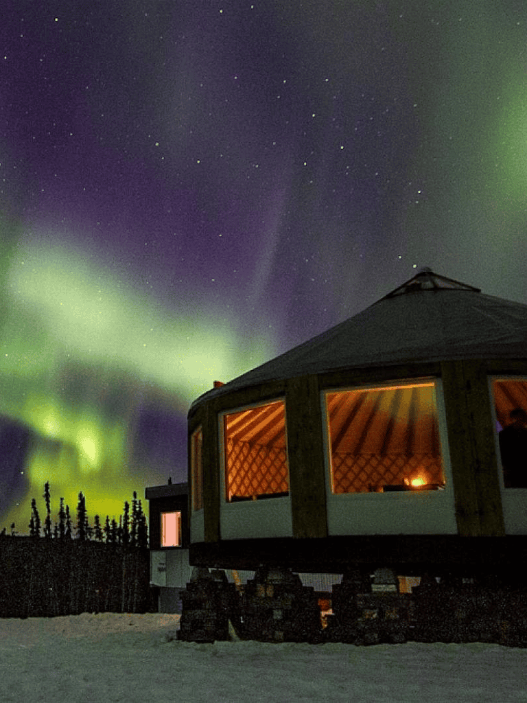 Aurora borealis over cozy cabin in snowy landscape, Northern Lights, travel, adventure, nature, night sky, destination, outdoor activities.