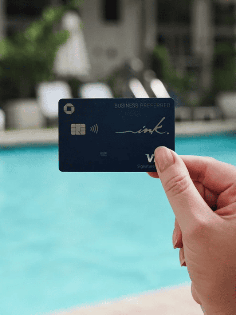 Contactless payment credit card at luxury poolside setting, modern, convenient transaction.