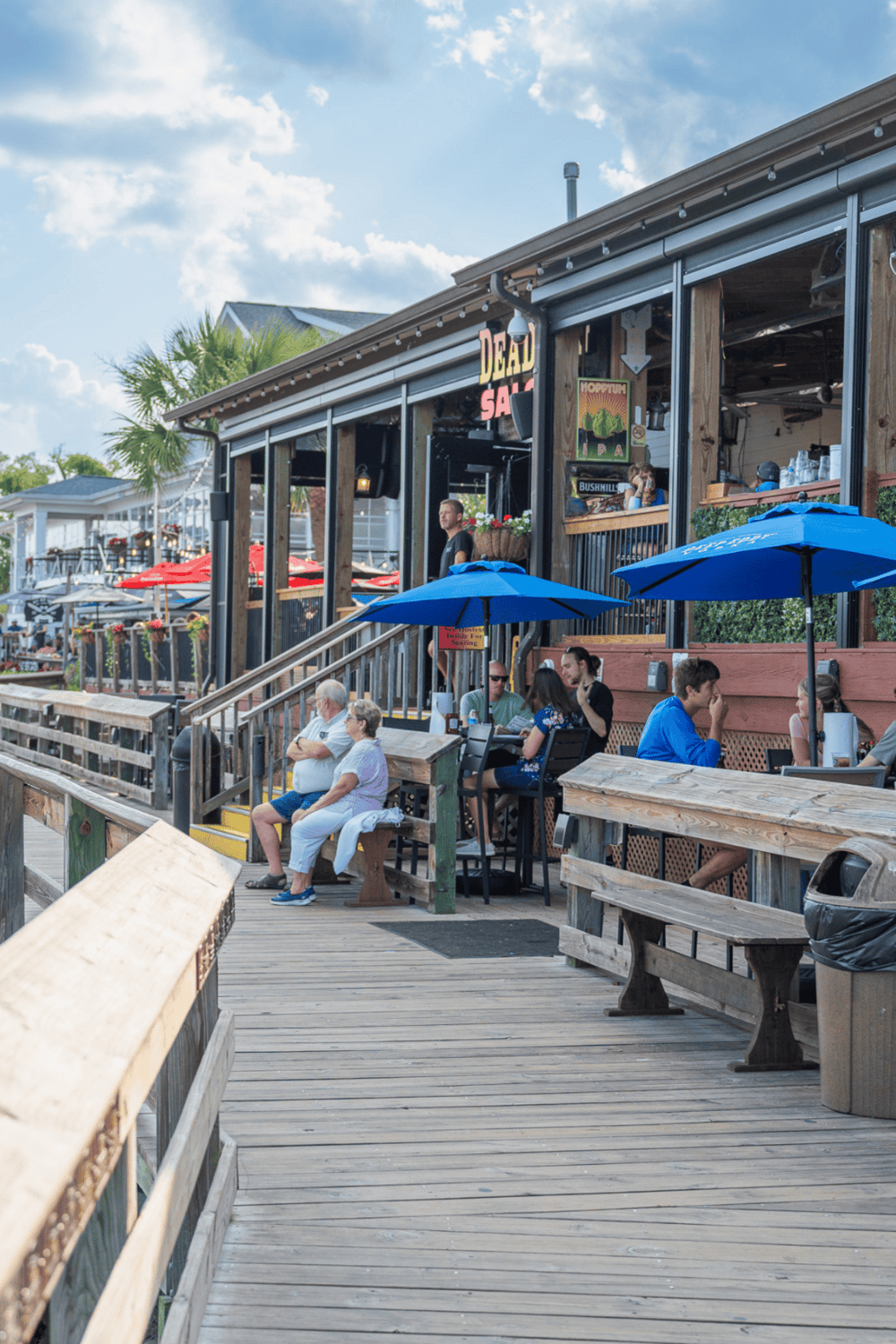 Outdoor waterfront restaurant at Quest For Directions, serving delicious seafood and drinks.