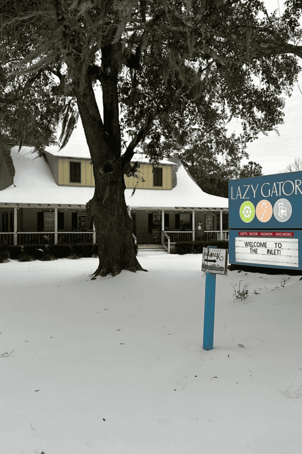 Historic house with surrounding snow, Lazy Gator sign, and Quest for Directions location.